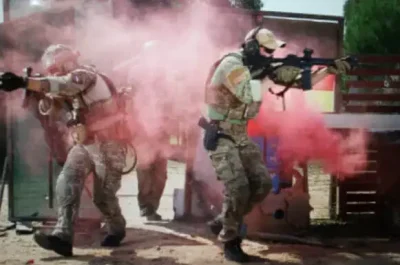 Two men in UCP Group uniforms participating in live training for hostile environments.